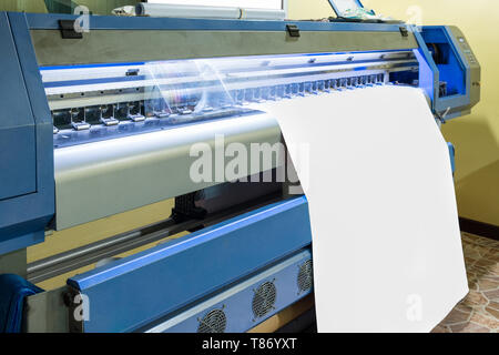 Large inkjet printer head working on white blank vinyl banner Stock Photo
