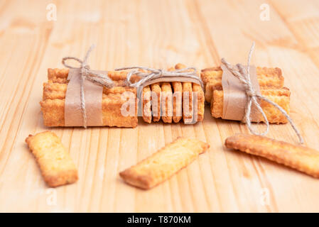 Salted crackers chained with string on a wooden table Stock Photo