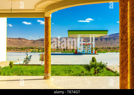 Green Gas Station in arid areas, in the desert, against the background of the Atlas Mountains in Morocco. Stock Photo