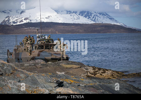 U.S. Marines with 1st Platoon, 1st Reconnaissance Battalion, 1st Marine Division, Marines with 1st Platoon, Force Reconnaissance Company, 2nd Marine Division, and the Norwegian Coastal Ranger Commando (KJK) conduct on-and-off CB90-class fast assault craft drills during exercise Platinum Ren at Fort Trondennes, Harstad, Norway, May 8, 2019.  The CB90 is a 500 horsepower class of fast military assault craft that can execute extremely sharp turns at high speeds and decelerate from top speed to a full stop in 2.5 boat lengths allowing the boats to operate in close proximity to one another.  Exerci Stock Photo