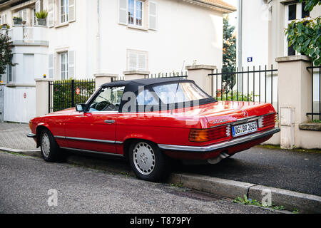 Strasbourg, France - May 19, 2017: Rear view of luxury vintage red convertible cabriolet Mercedes-Benz 300 Sl parked in front of French luxury house in calm neighborhood Stock Photo