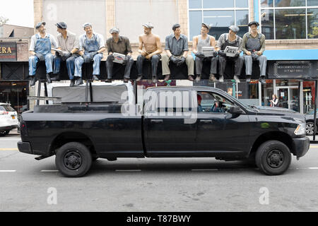 A delivery truck with a reproduction of the famous photo of construction workers eating lunch atop a skyscraper. In Astoria, Queens, New York. Stock Photo