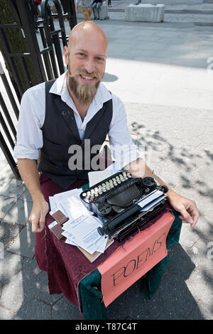 POET FOR HIRE who writes personalized  poems on his typewriter for a fee. In Union Square Park in manhattan, New York City. Stock Photo