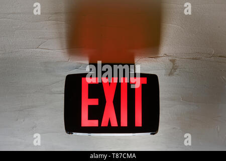 Red Exit Sign on Ceiling Stock Photo