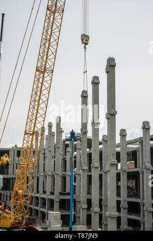 Sibiu, Romania - April 06, 2019. workers with cranes at The mall Festival Centrum building site from Sibiu city, Romania Stock Photo