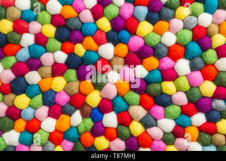 Multicolored felt ball rug detail, colorful texture Stock Photo