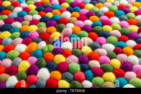 Multicolored felt ball rug detail, colorful texture Stock Photo