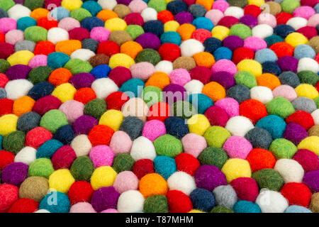 Multicolored felt ball rug detail, colorful texture Stock Photo