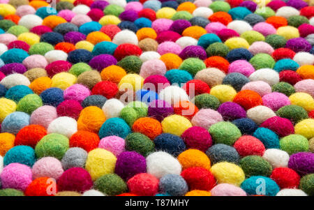 Multicolored felt ball rug detail, colorful texture Stock Photo