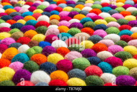 Multicolored felt ball rug detail, colorful texture Stock Photo