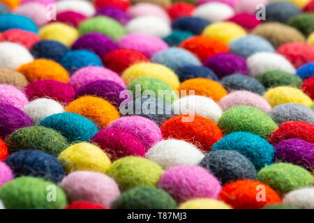 Multicolored felt ball rug detail, colorful texture Stock Photo
