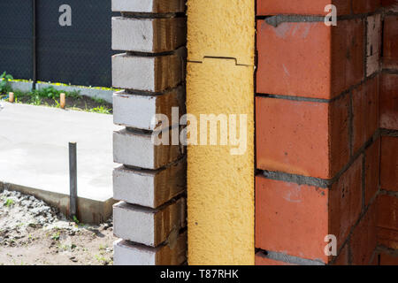 Close up of cavity wall insulation boards fitted in masonry cavities in newly built house used to reduce heat loss