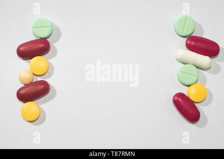 Variety of pills and medical tablets arranged vertically with copy space Stock Photo