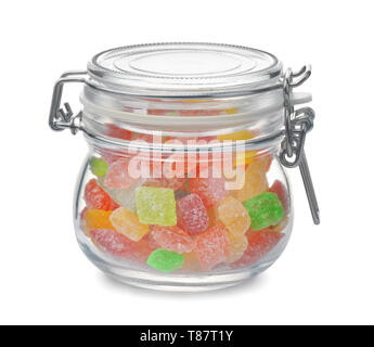 Glass jar full of colorful hard candies isolated on white Stock Photo