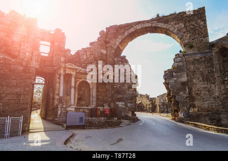 The ruins of the central gate of the ancient city of Side in Turkey in the light of the setting sun Stock Photo