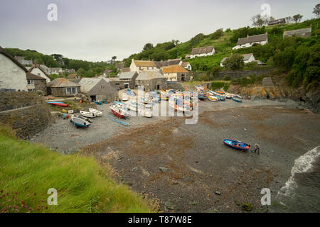 Traditional fishing boats on the beach of the small fishing village of Cadgwith,Cornwall, England,UK. Fishermen still push their boats down the beach. Stock Photo