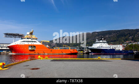 Offshore AHTS supply vessels Normand Prosper and Island Vanguard in the port of Bergen, Norway. Skoltegrunnskaien terminal. Stock Photo