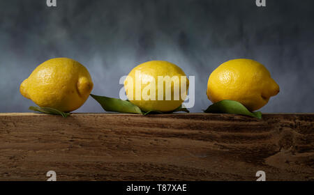 Three lemons with leaves Stock Photo
