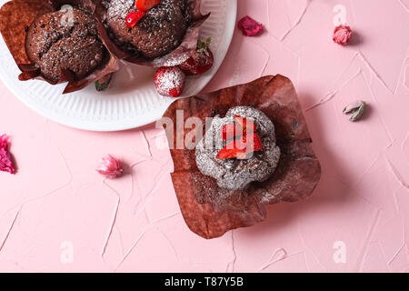 Tasty chocolate muffins on color table Stock Photo