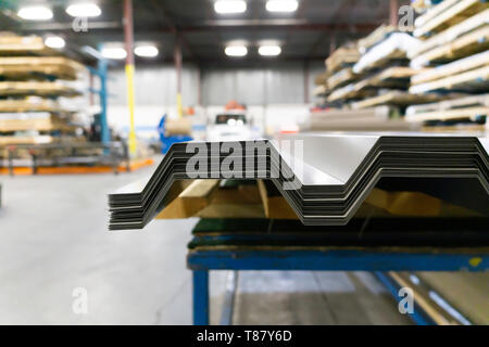 Corrugated galvanised metal roofing sheets on factory workshop Stock Photo