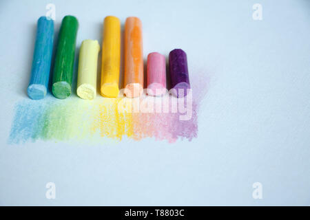 Close up view of the colorful chalk pastels on the white background, soft focus Stock Photo