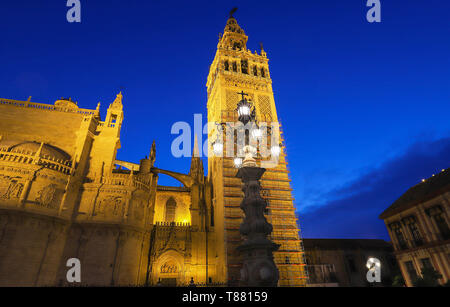 Famous tower of Giralda, Islamic architecture built by the Almohads and crowned by a Renaissance bell tower with the statue of Giraldillo at its Stock Photo