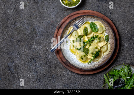 Italian spinach ricotta ravioli, Top view, black background, copy space, Vegetarian food, vegan ravioli Stock Photo