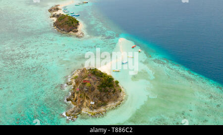 Small tropical island with a white beach. Clear sea with coral reef, top view. Philippines, Palawan Stock Photo