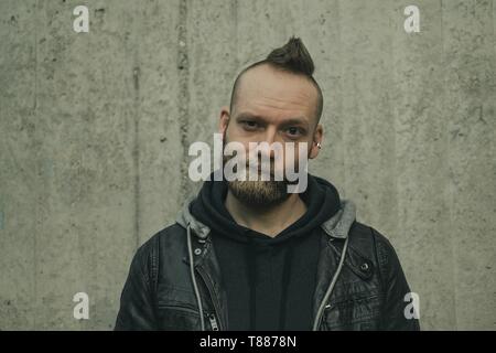 young man in casual clothes looks disillusioned into the camera Stock Photo