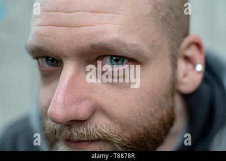 serious looking bearded man looks into the camera Stock Photo