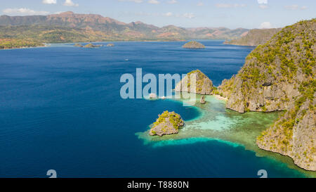 Tropical islands of the Malay Archipelago. Many islands with turquoise lagoons and coral reefs aerial view. Philippines, Palawan Stock Photo