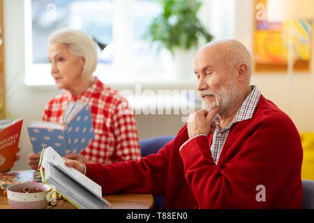 Nice thoughtful senior man touching his chin Stock Photo