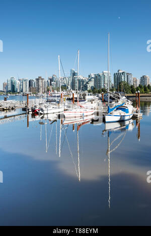 Standing on the seawall next to the Vancouver Rowing Club looking across Coal Harbour bay towards the downtown area & towering glass apartments. Stock Photo