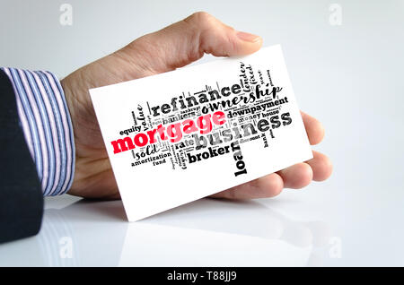 Mortgage word cloud collage over note in human hand Stock Photo