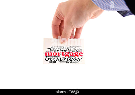Mortgage word cloud collage over note in human hand Stock Photo