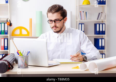 Young male architect working in the office Stock Photo