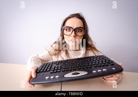 Funny nerd girl working on computer Stock Photo