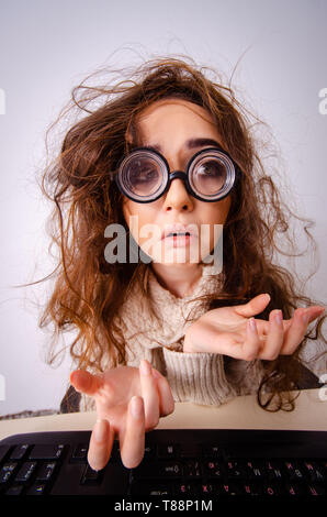 Funny nerd girl working on computer Stock Photo