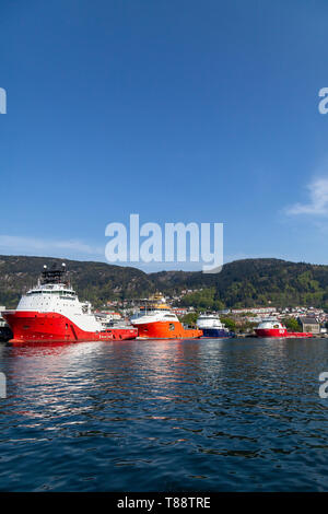 Offshore AHTS supply vessels Siem Ruby, Normand Prosper, Island Vanguard and Skandi Bergen in the port of Bergen, Norway Stock Photo