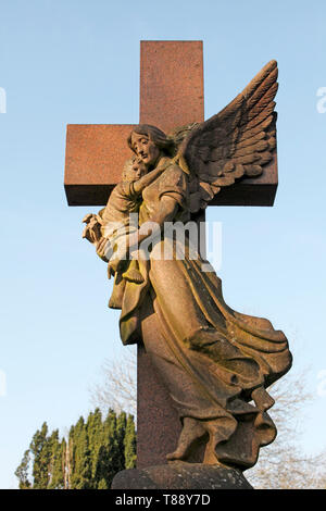 Mother and child, angel, protection, child's grave. Cross Stock Photo