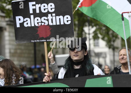 A protester is seen holding a placard that says free Palestine during the demonstration. Palestinian human rights activist Ahed Tamimi joined the National demo for Palestine. Protesters gathered at Portland Place and marched to Whitehall in London, joining a global demonstration to show solidarity for Palestinian citizens and also to demand respect for the Palestinians rights and defend the rights to return to their territory. Stock Photo