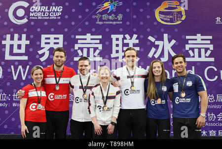 Beijing, China. 12th May, 2019. Team Norway (C), Team Canada 1 (L) and Team the United States pose at the awarding ceremony of the 2018-2019 WCF Curling World Cup Grand Final mixed doubles event at the Shougang Ice Hockey Arena in Beijing, capital of China, May 12, 2019. Credit: Luo Yuan/Xinhua/Alamy Live News Stock Photo