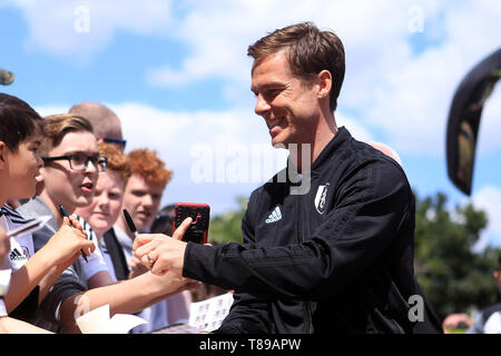 London, UK. 12th May, 2019. Fulham Manager Scott Parker signs autographs for fans outside the ground. Premier League match, Fulham v Newcastle Utd at Craven Cottage in London on Sunday 12th May 2019.  this image may only be used for Editorial purposes. Editorial use only, license required for commercial use. No use in betting, games or a single club/league/player publications. Credit: Andrew Orchard sports photography/Alamy Live News Stock Photo