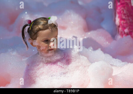 Weymouth, Dorset, UK. 12th May 2019. Weldmar's last ever Bubble Rush takes place at Weymouth to raise funds for the charity. Participants have fun getting covered in foam, running through bubbles of different colours. Credit: Carolyn Jenkins/Alamy Live News Stock Photo