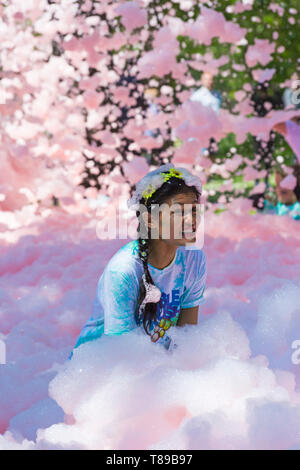 Weymouth, Dorset, UK. 12th May 2019. Weldmar's last ever Bubble Rush takes place at Weymouth to raise funds for the charity. Participants have fun getting covered in foam, running through bubbles of different colours. Credit: Carolyn Jenkins/Alamy Live News Stock Photo