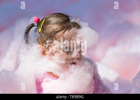 Weymouth, Dorset, UK. 12th May 2019. Weldmar's last ever Bubble Rush takes place at Weymouth to raise funds for the charity. Participants have fun getting covered in foam, running through bubbles of different colours. Credit: Carolyn Jenkins/Alamy Live News Stock Photo