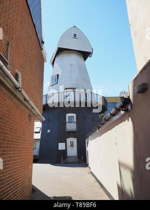 Sheerness, Kent, UK. 12th May, 2019. National Mills Weekend is the annual festival celebrating the UK's milling heritage. Pictured is Watson's Mill (formerly the Great Mill) in Sheerness which lies close to the town centre. Since 1924 the mill stood in ruin after being demolished, until being rebuilt by Caleb Watson in 2006, with fire almost destroying the rebuild in 2008 before it was due to be finished. It's a prominent local landmark but not open to the public; the ground floor has been taken over by a local insurance company. It's a Grade II  smock mill. Credit: James Bell/Alamy Live News Stock Photo