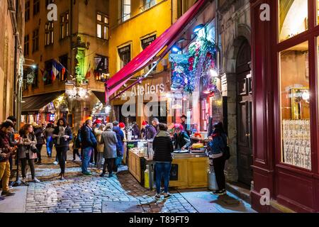 France, Rhone, Lyon, district of Cordeliers, Vieux-Lyon, street of la Monnaie, historical site listed as World Heritage by UNESCO, oysters and white wine as an aperitif in front of a Bouchon during the Fete des Lumieres (Light Festival) Stock Photo