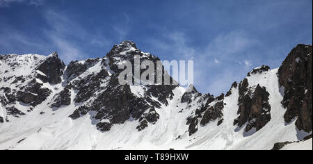 Panoramic view on snowy sunlight rocks with traces from avalanches in sunny spring day. Turkey, Kachkar Mountains, highest part of Pontic Mountains. Stock Photo