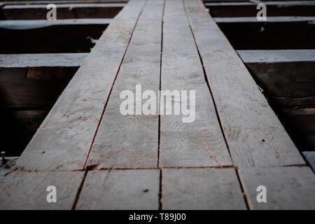 old wooden board floor  or plank construction in attic loft Stock Photo